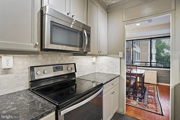 a kitchen with a stove and a microwave
