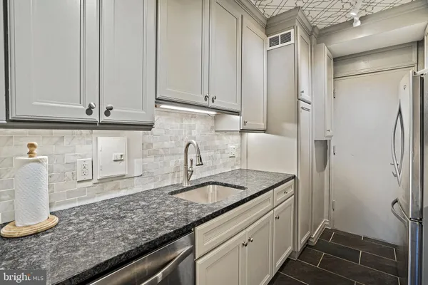 a kitchen with a sink and cabinets