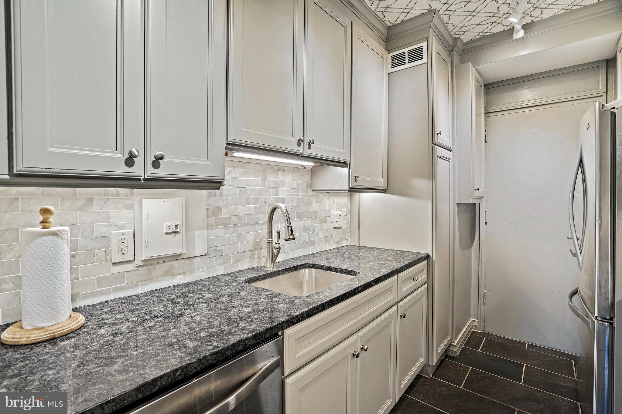4740 Connecticut Avenue Northwest, Unit 404 Washington, DC 20008 - Photo 8 of 24 a kitchen with a sink and cabinets