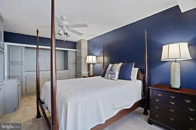 a bedroom with a bed and a flat tv screen on dresser