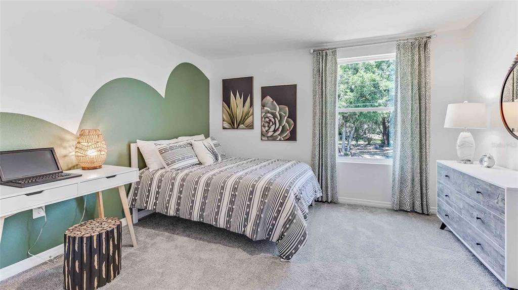 17811 Acorn Drop Road Land O Lakes, FL 34638 - Photo 5 of 11 a spacious bedroom with two beds and a window