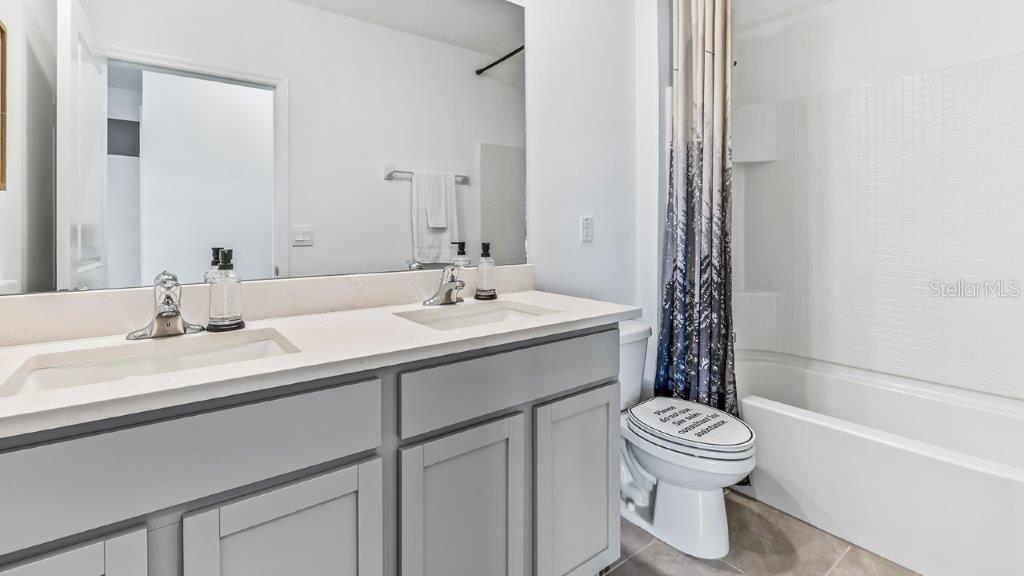17811 Acorn Drop Road Land O Lakes, FL 34638 - Photo 7 of 11 a bathroom with a sink toilet and shower