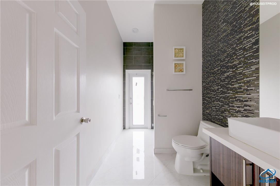 4524 Southwest 195th Way Miramar, FL 33029 - Photo 15 of 36 a white toilet sitting next to a bathroom sink