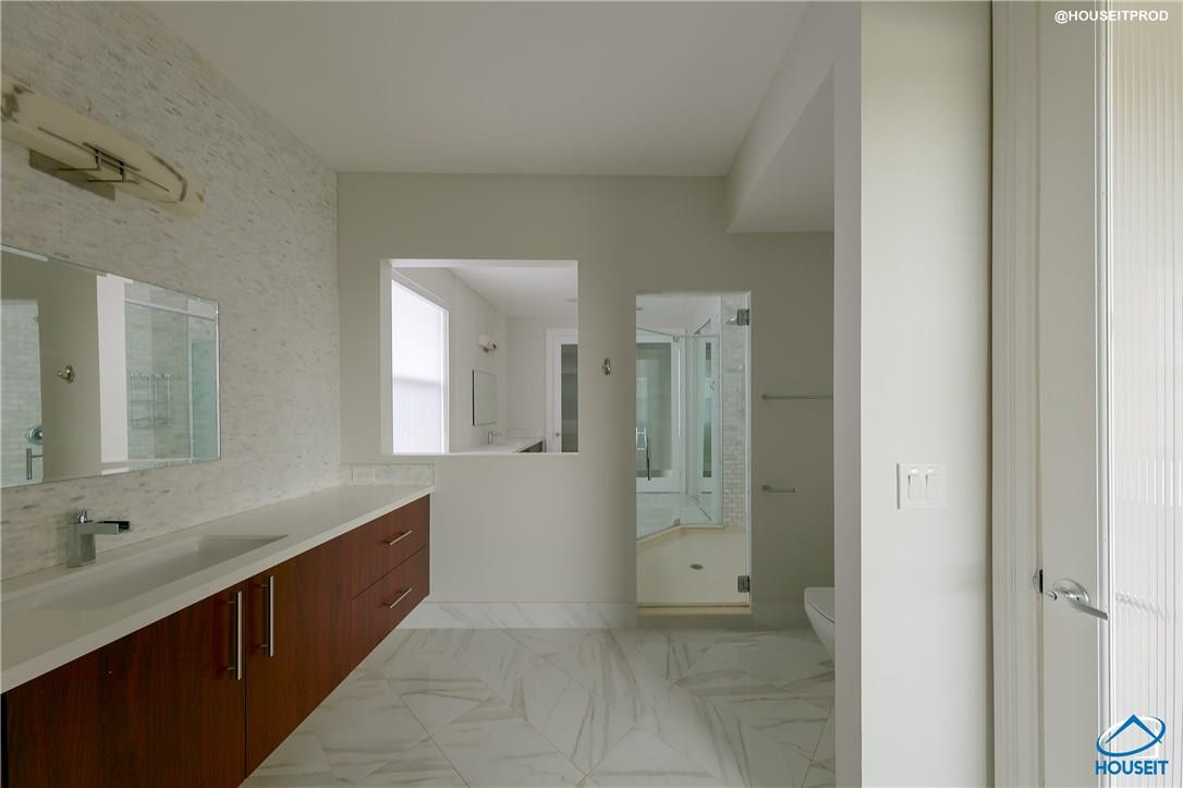4524 Southwest 195th Way Miramar, FL 33029 - Photo 22 of 36 a spacious bathroom with a double vanity sink a mirror and a shower