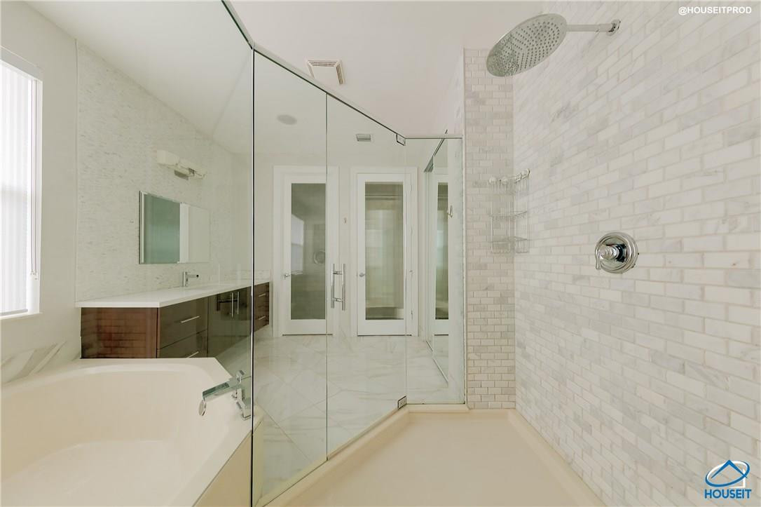 4524 Southwest 195th Way Miramar, FL 33029 - Photo 23 of 36 a bathroom with a tub a sink and a shower