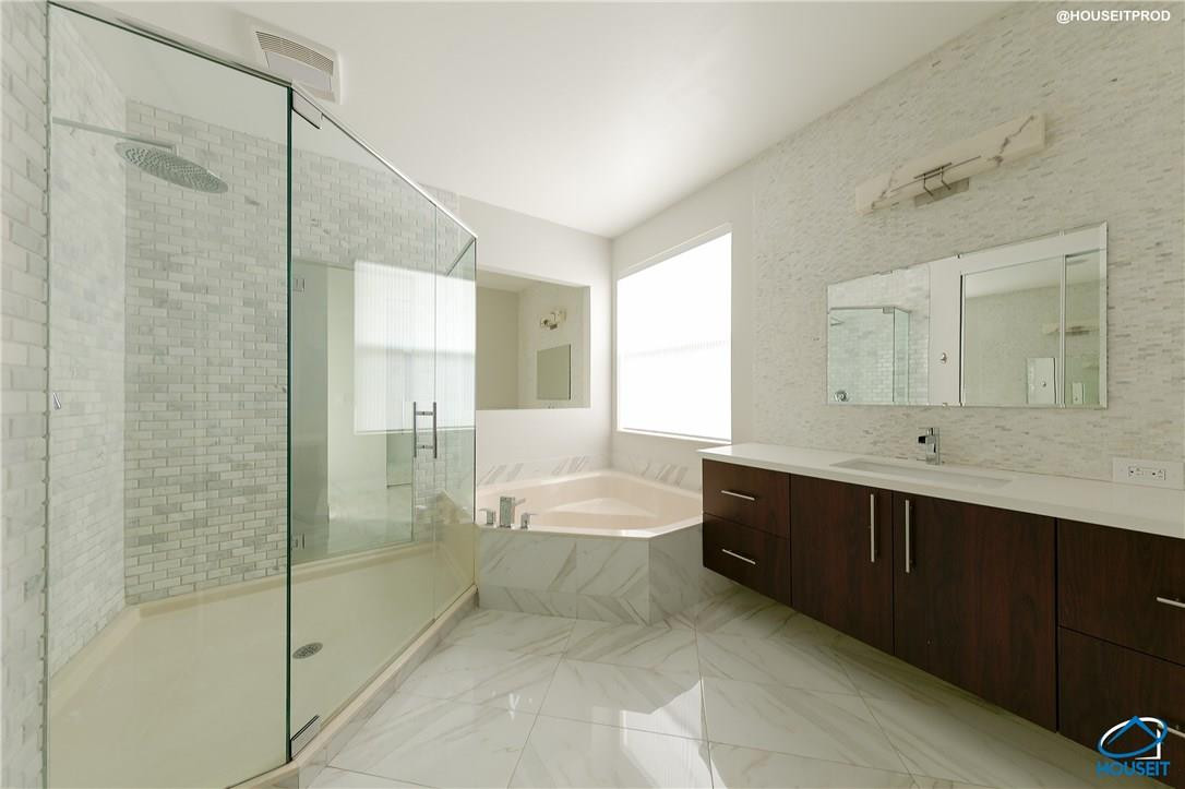 4524 Southwest 195th Way Miramar, FL 33029 - Photo 24 of 36 a spacious bathroom with a shower sink and mirror