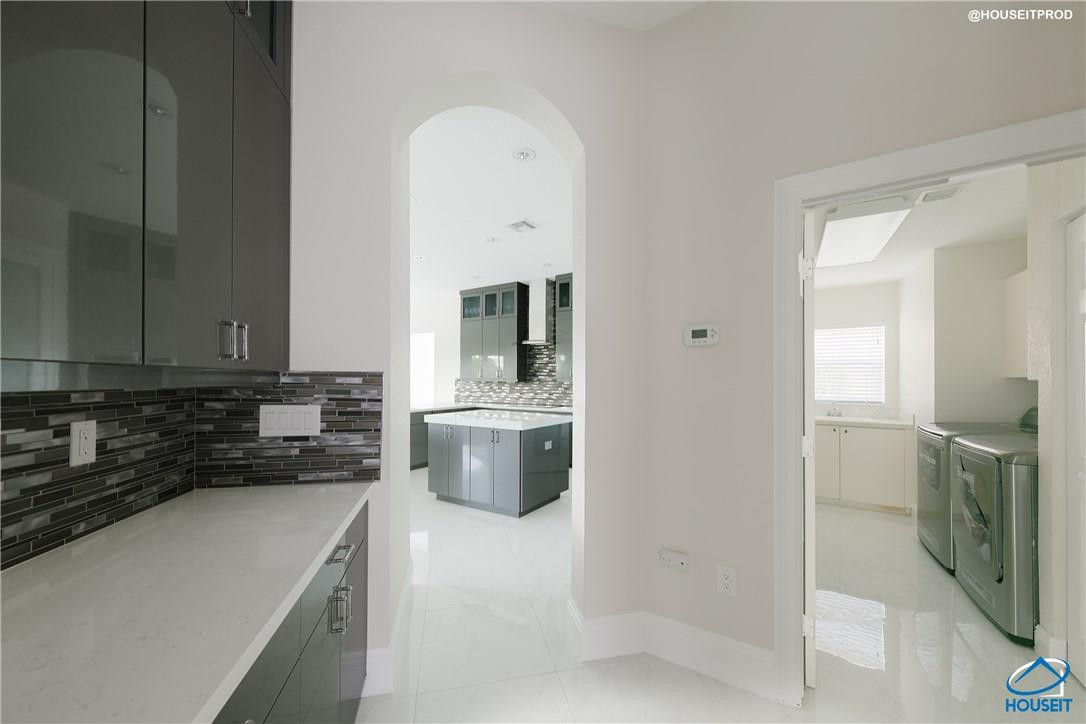 4524 Southwest 195th Way Miramar, FL 33029 - Photo 28 of 36 a kitchen with a sink and a stove top oven