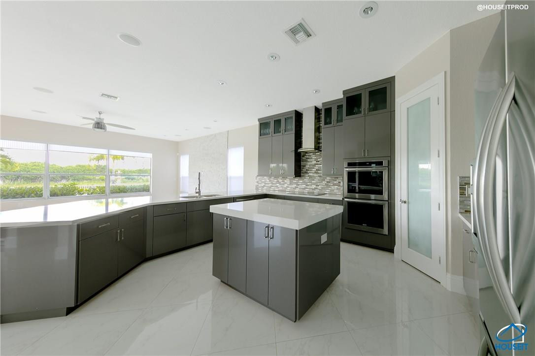 4524 Southwest 195th Way Miramar, FL 33029 - Photo 30 of 36 a kitchen with stainless steel appliances granite countertop a refrigerator a sink a stove and a refrigerator