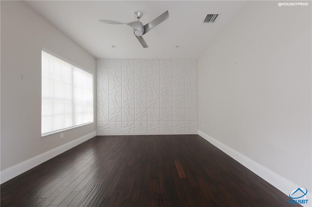 4524 Southwest 195th Way Miramar, FL 33029 - Photo 34 of 36 an empty room with wooden floor and windows