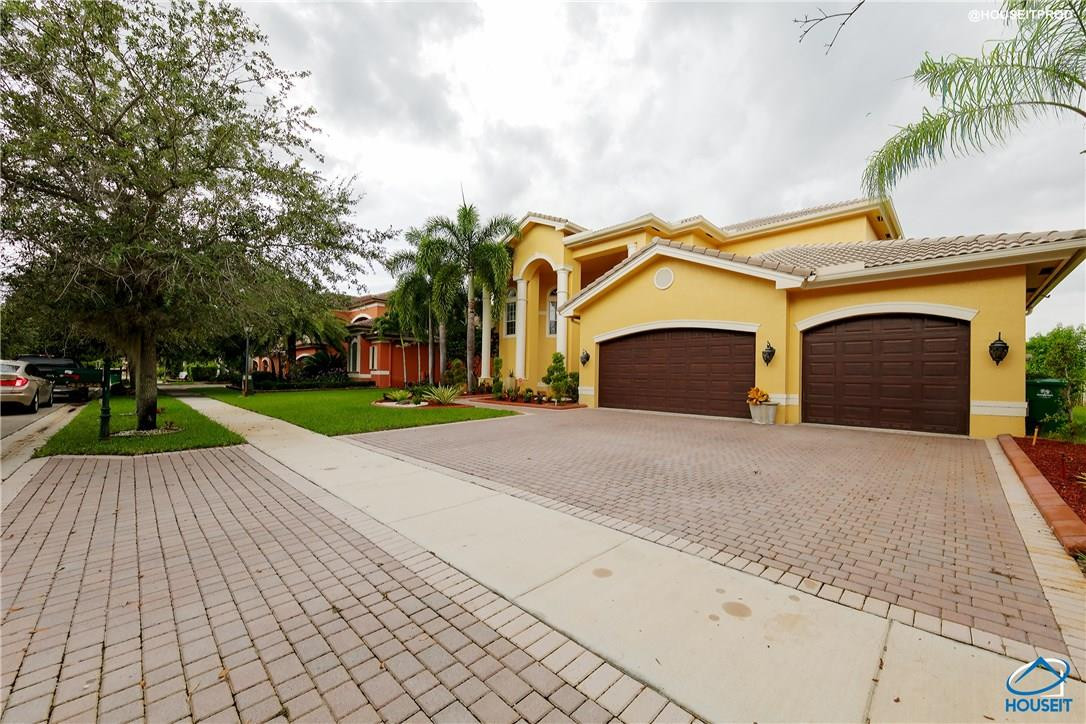 4524 Southwest 195th Way Miramar, FL 33029 - Photo 5 of 36 a front view of a house with a yard and garage