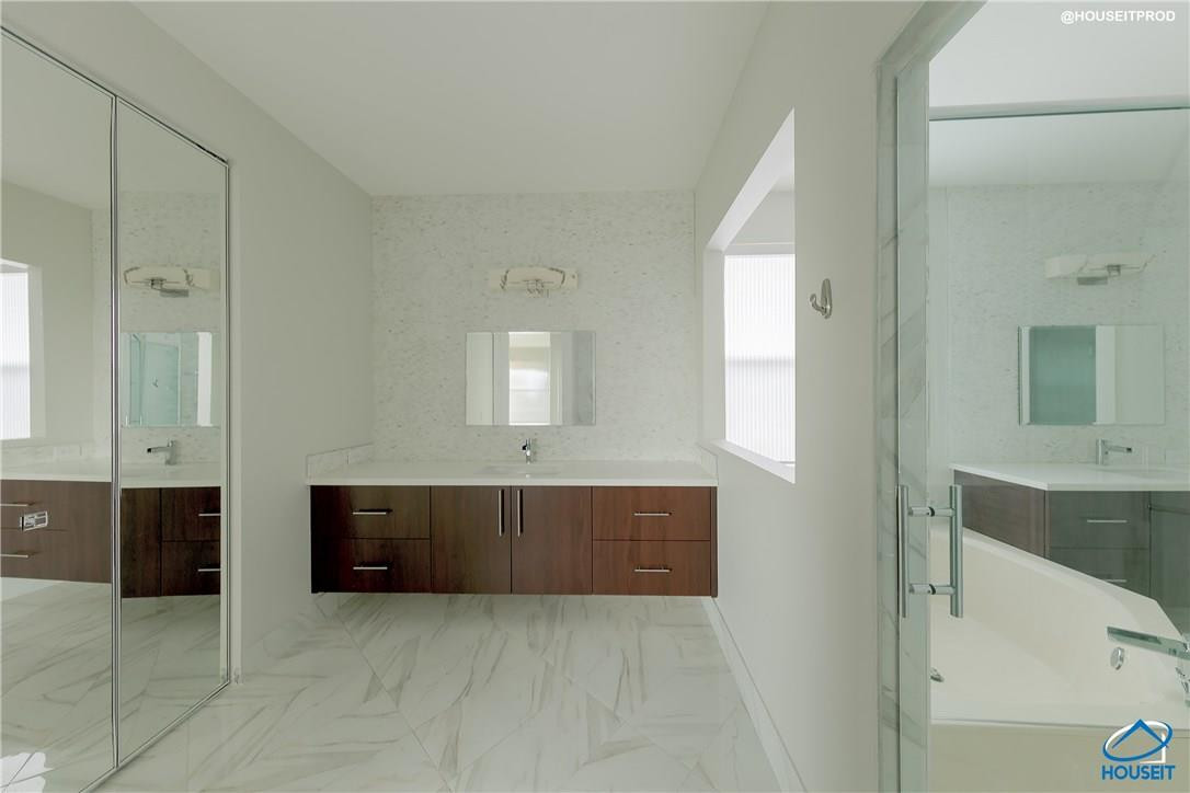 4524 Southwest 195th Way Miramar, FL 33029 - Photo 9 of 36 a spacious bathroom with a tub sink and mirror