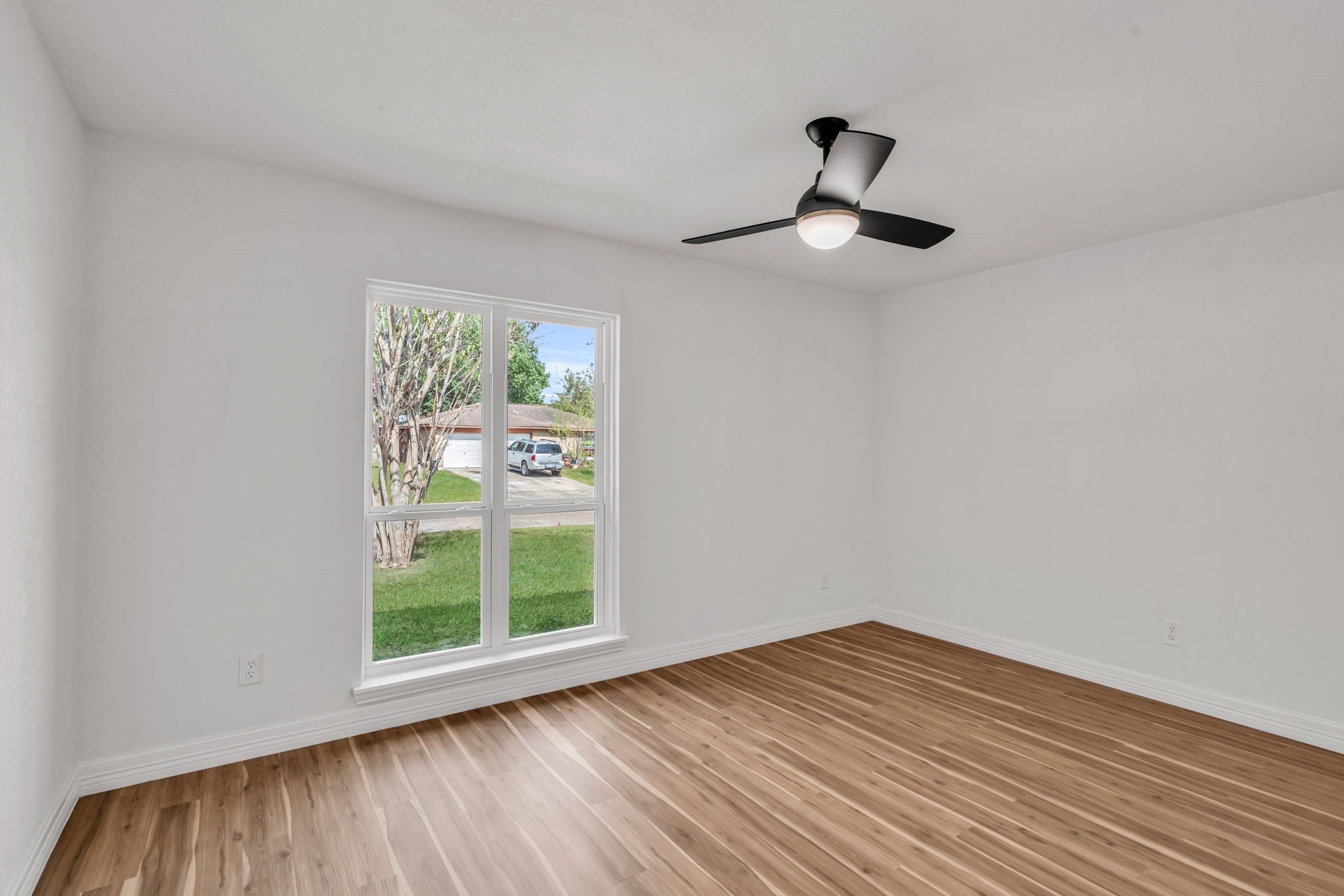 12426 Enchanted Path Drive Houston, TX 77044 - Photo 14 of 28 a view of empty room with wooden floor and fan