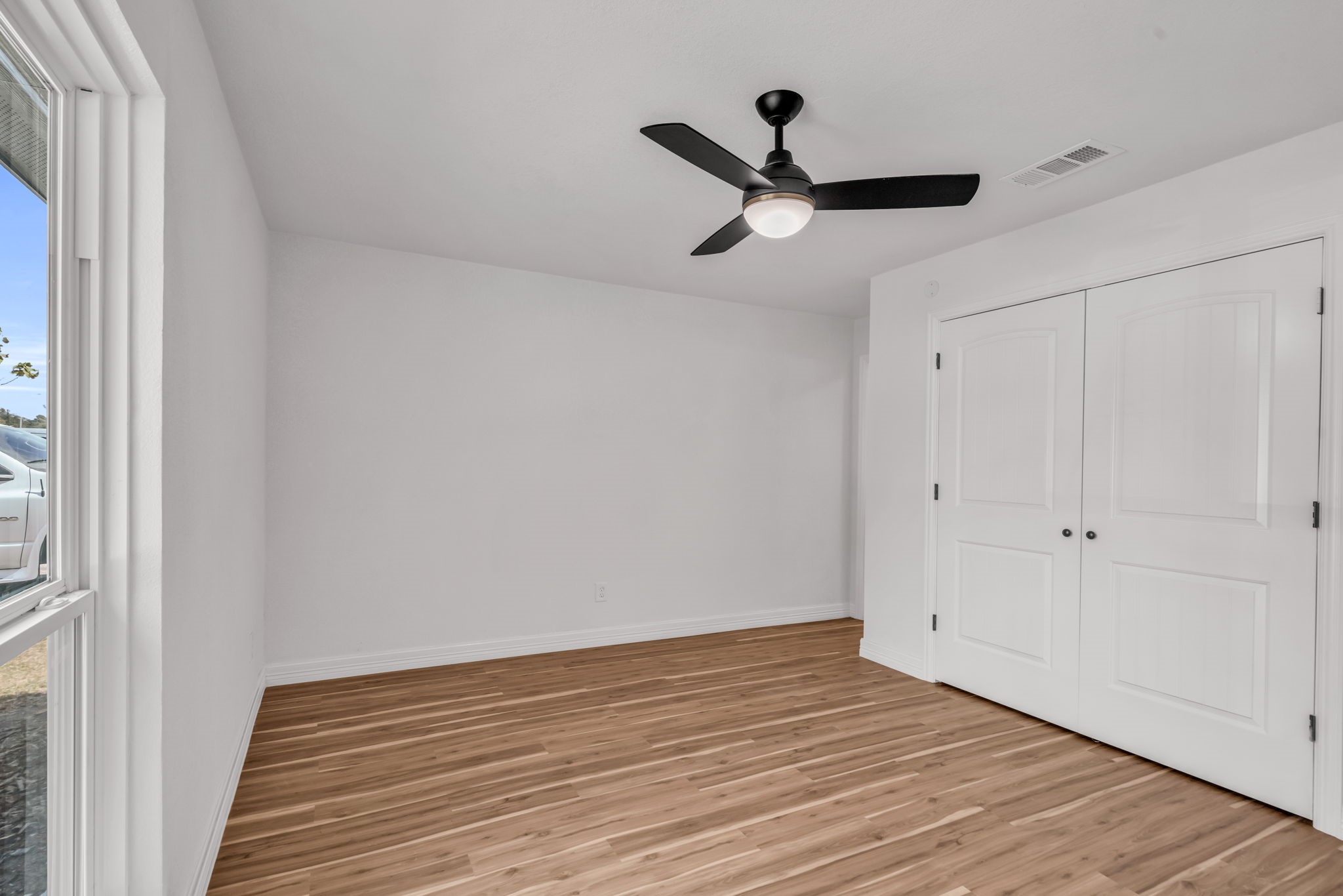 12426 Enchanted Path Drive Houston, TX 77044 - Photo 15 of 28 a view of empty room with wooden floor and ceiling fan