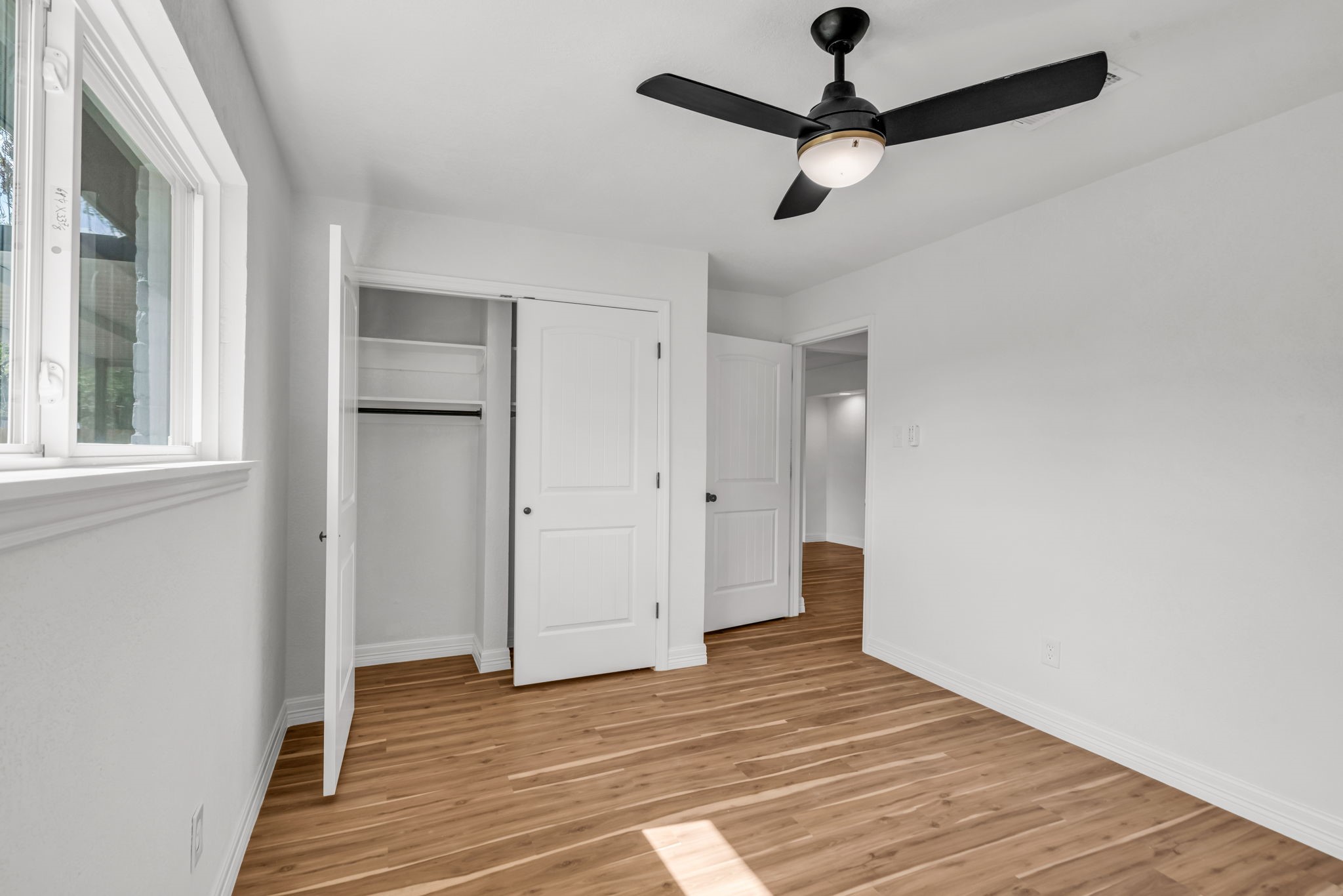 12426 Enchanted Path Drive Houston, TX 77044 - Photo 21 of 28 a view of an empty room with wooden floor and a window