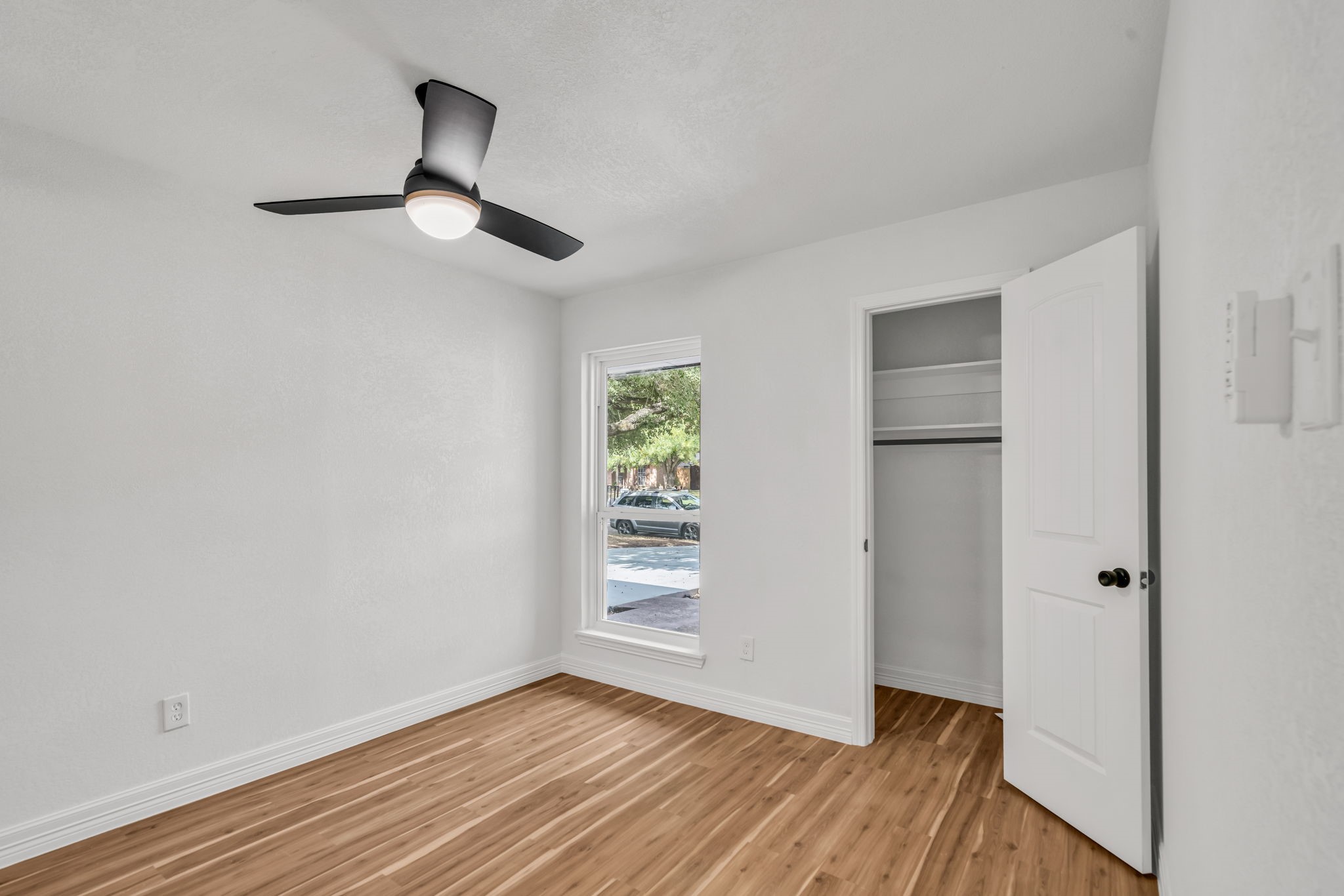 12426 Enchanted Path Drive Houston, TX 77044 - Photo 22 of 28 an empty room with wooden floor cabinet and windows