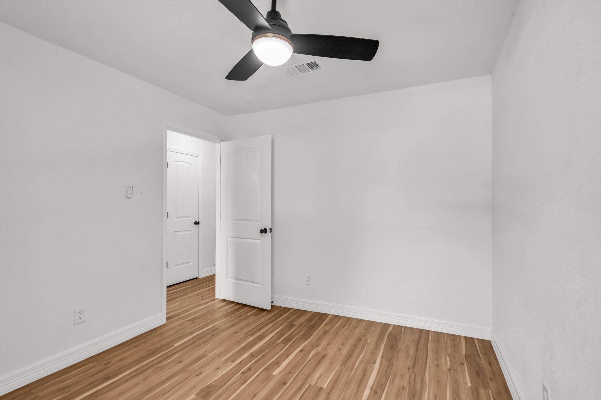 12426 Enchanted Path Drive Houston, TX 77044 - Photo 23 of 28 a view of an empty room and wooden floor