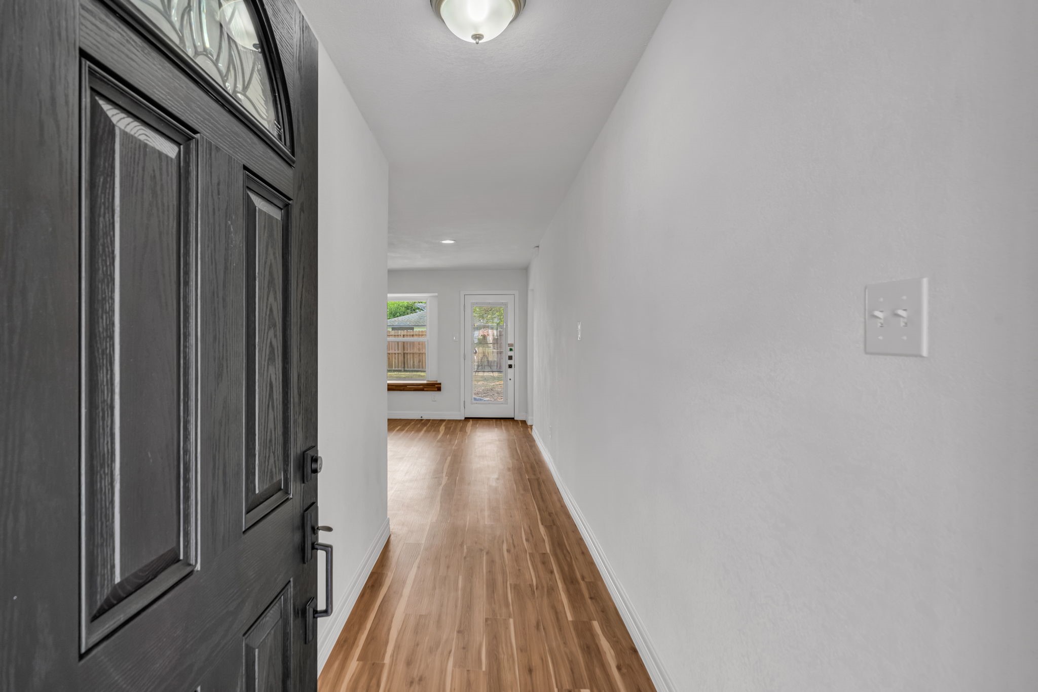12426 Enchanted Path Drive Houston, TX 77044 - Photo 25 of 28 a view of a hallway with wooden floor and staircase