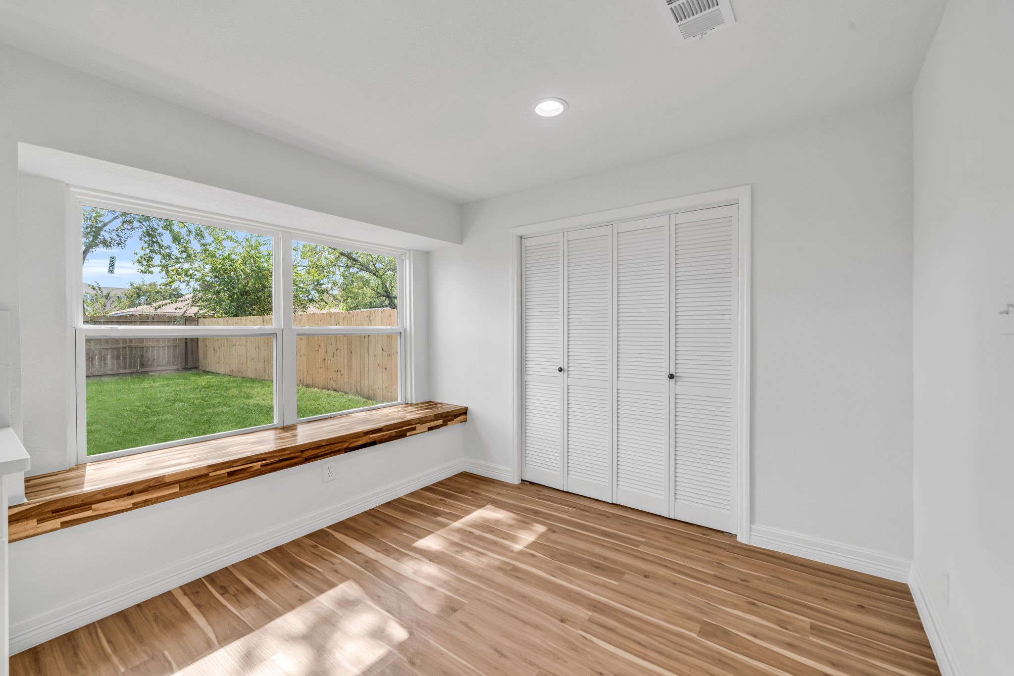 12426 Enchanted Path Drive Houston, TX 77044 - Photo 27 of 28 a view of a room with wooden floor and windows