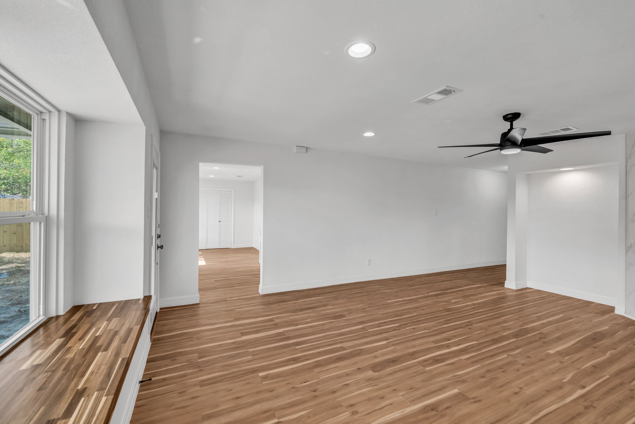 12426 Enchanted Path Drive Houston, TX 77044 - Photo 9 of 28 a view of empty room with wooden floor and fan