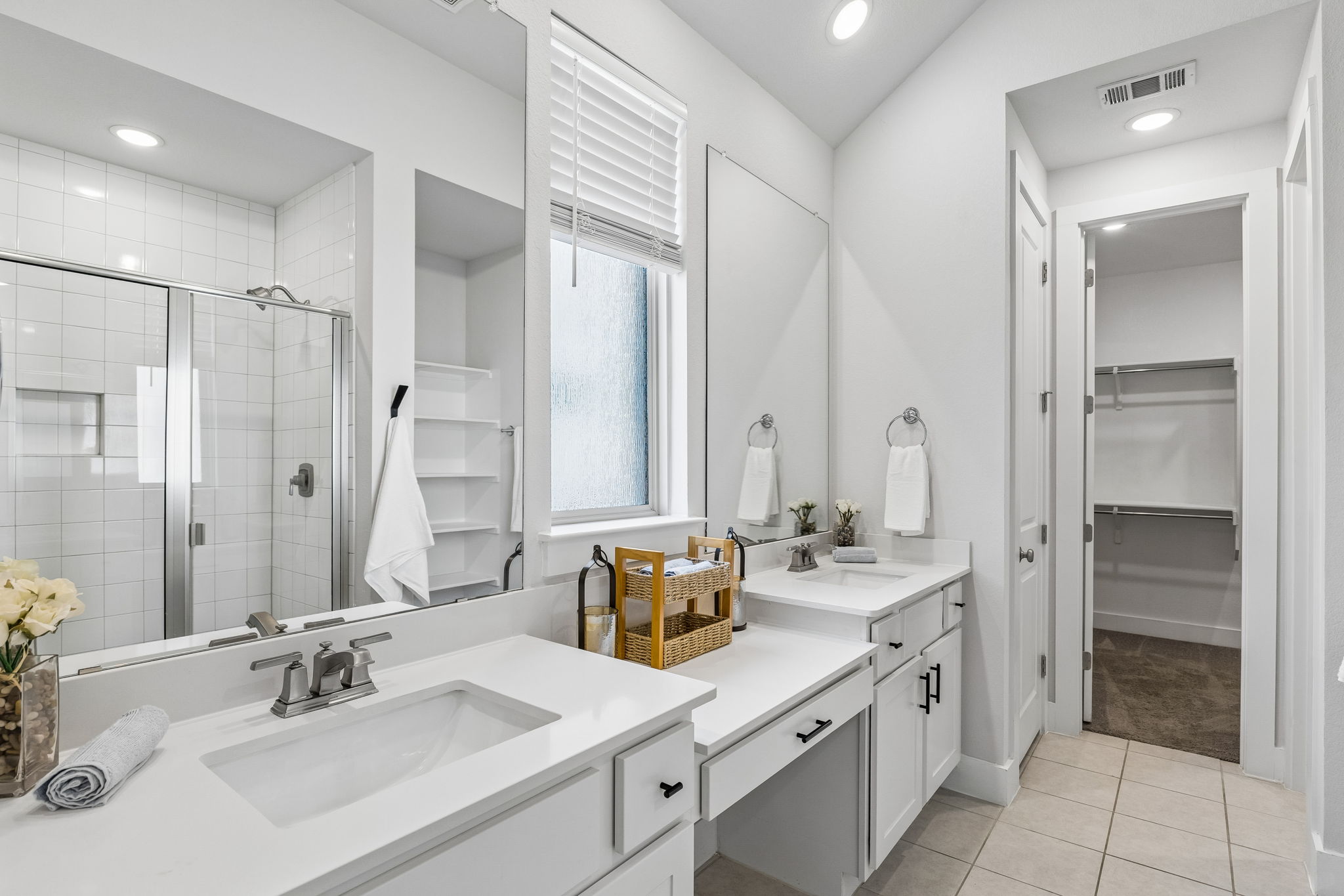 228 Arrowhead Mound Road Georgetown, TX 78628 - Photo 15 of 34 Dual vanities and a spacious walk-in closet highlight this pristine, well-appointed bathroom.