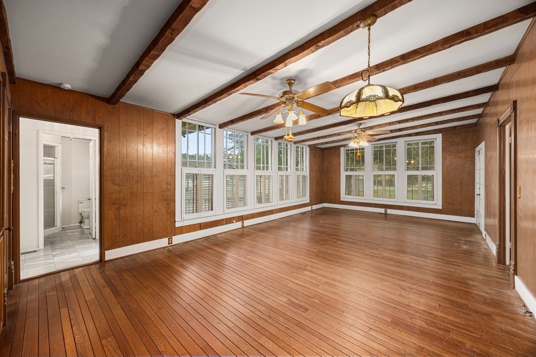 236 Preston Street Columbus, TX 78934 - Photo 13 of 50 a view of an empty room with wooden floor and a window