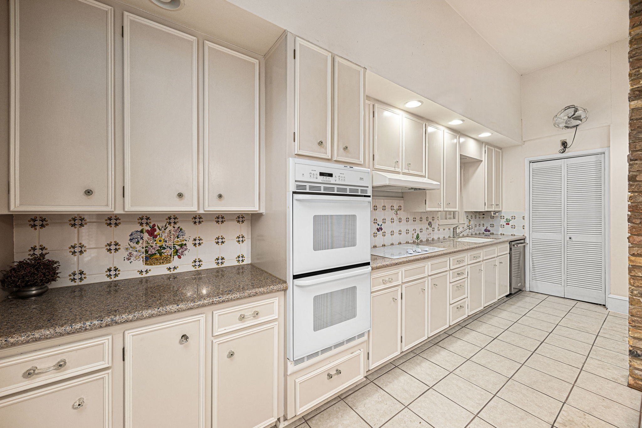 236 Preston Street Columbus, TX 78934 - Photo 17 of 50 a kitchen with granite countertop white cabinets and white appliances