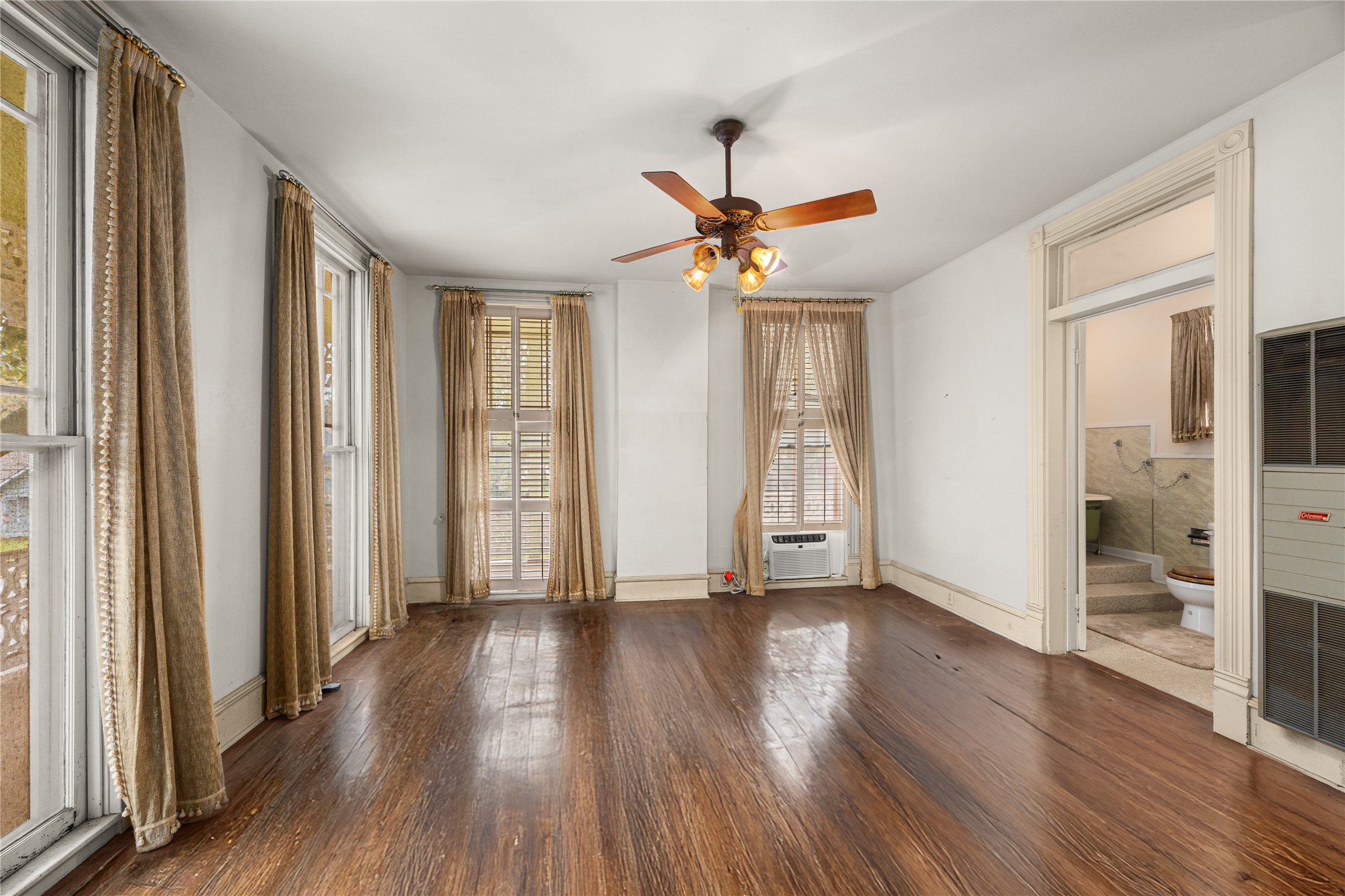 236 Preston Street Columbus, TX 78934 - Photo 33 of 50 a view of an empty room with wooden floor and a window
