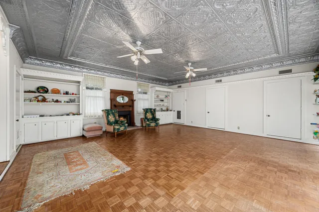 a view of a livingroom with hardwood floor and a ceiling fan