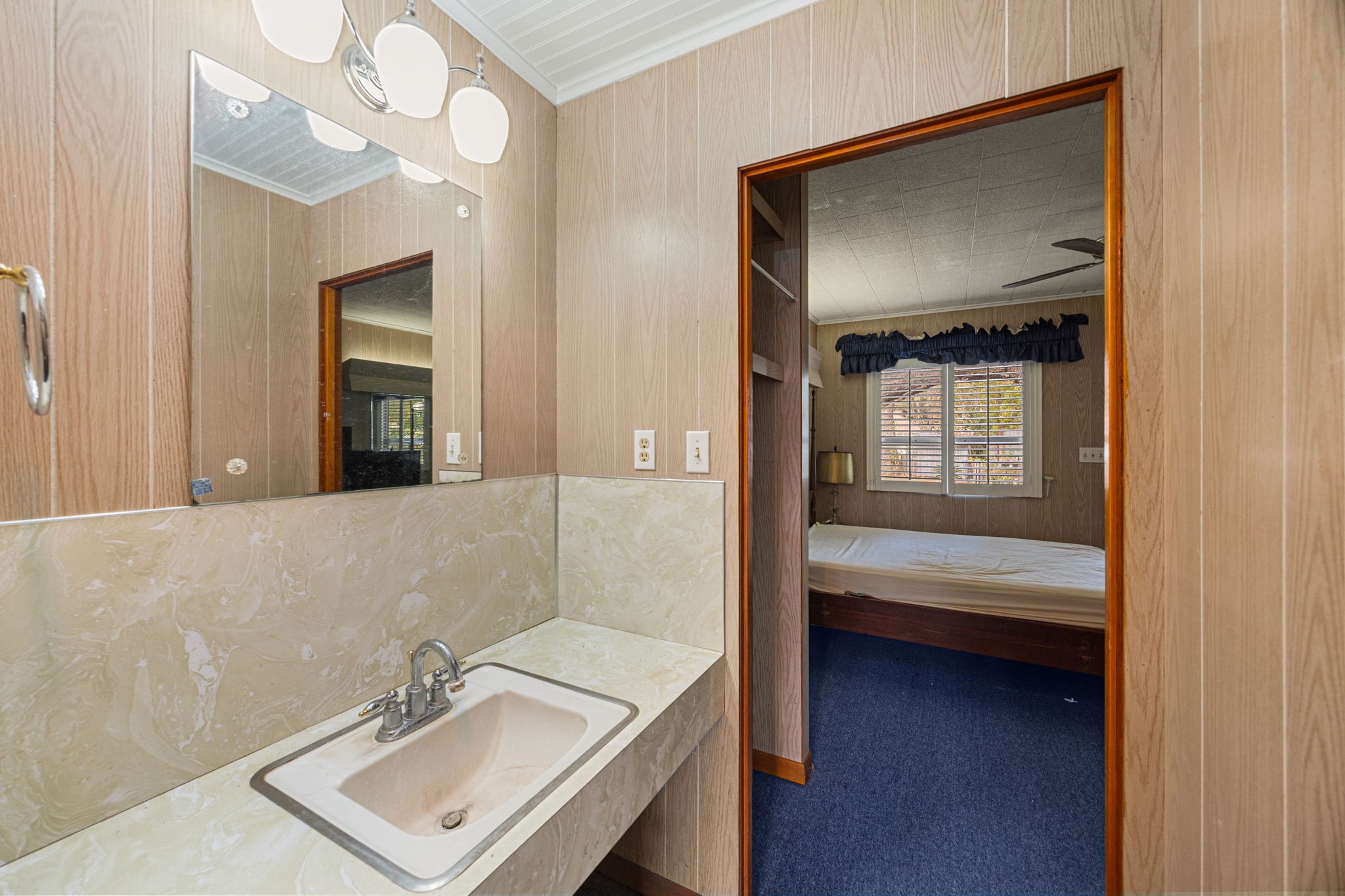 236 Preston Street Columbus, TX 78934 - Photo 49 of 50 a en suite bathroom with a sink a light fixture and a mirror