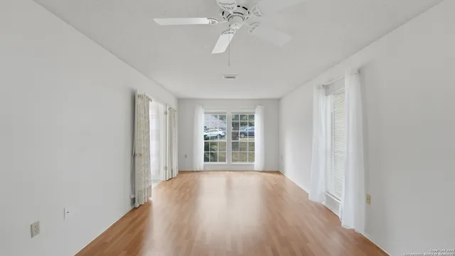 wooden floor in an empty room with a window