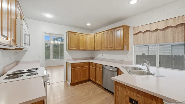 a kitchen with a sink stove and cabinets