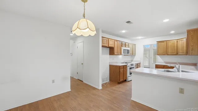 a kitchen with stainless steel appliances a refrigerator sink and stove