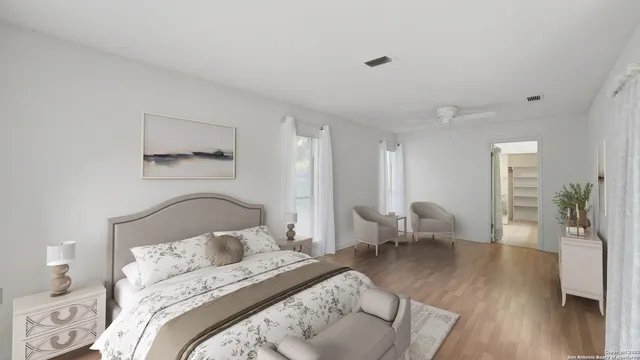 a bedroom with bed and wooden floor