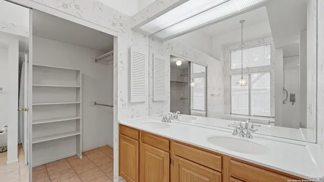 a bathroom with a double vanity sink and mirror