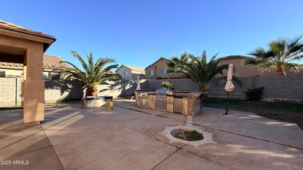 a view of a house with backyard and sitting area