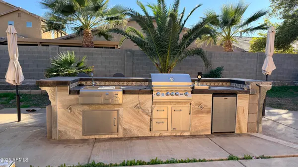 a white house with tree in front of it