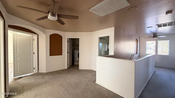 a view of a livingroom with furniture and chandelier fan