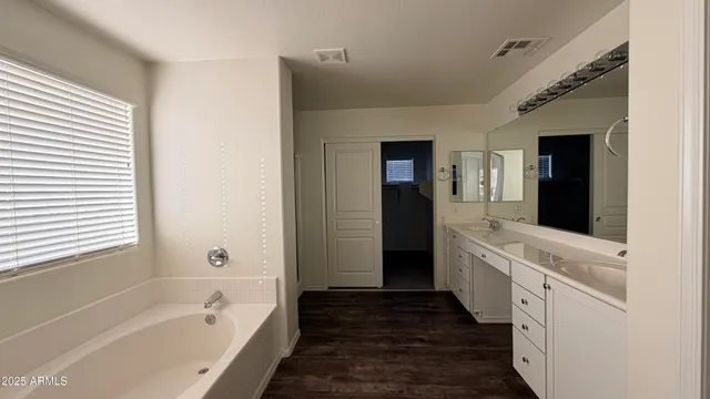 a bathroom with a bathtub and a sink