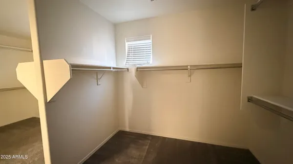 a view of a small space with wooden floor and a window