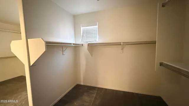 a view of a small space with wooden floor and a window