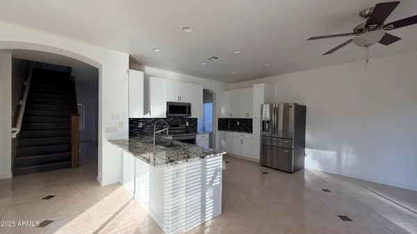 a kitchen with refrigerator and microwave