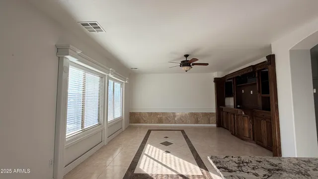 a bathroom with a tub shower and windows