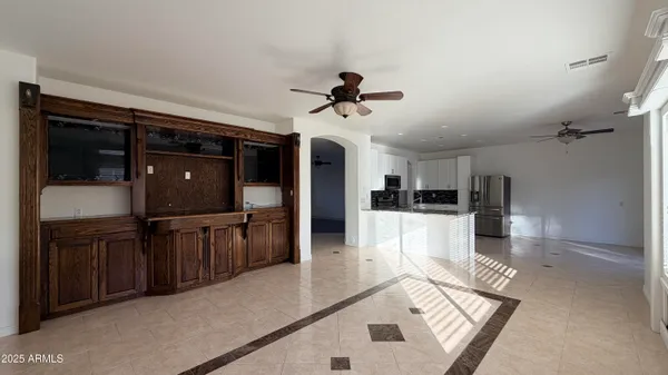 a view of living room kitchen with stainless steel appliances cabinets
