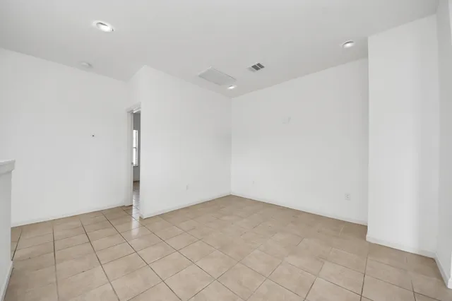 an empty room with white walls and tiles