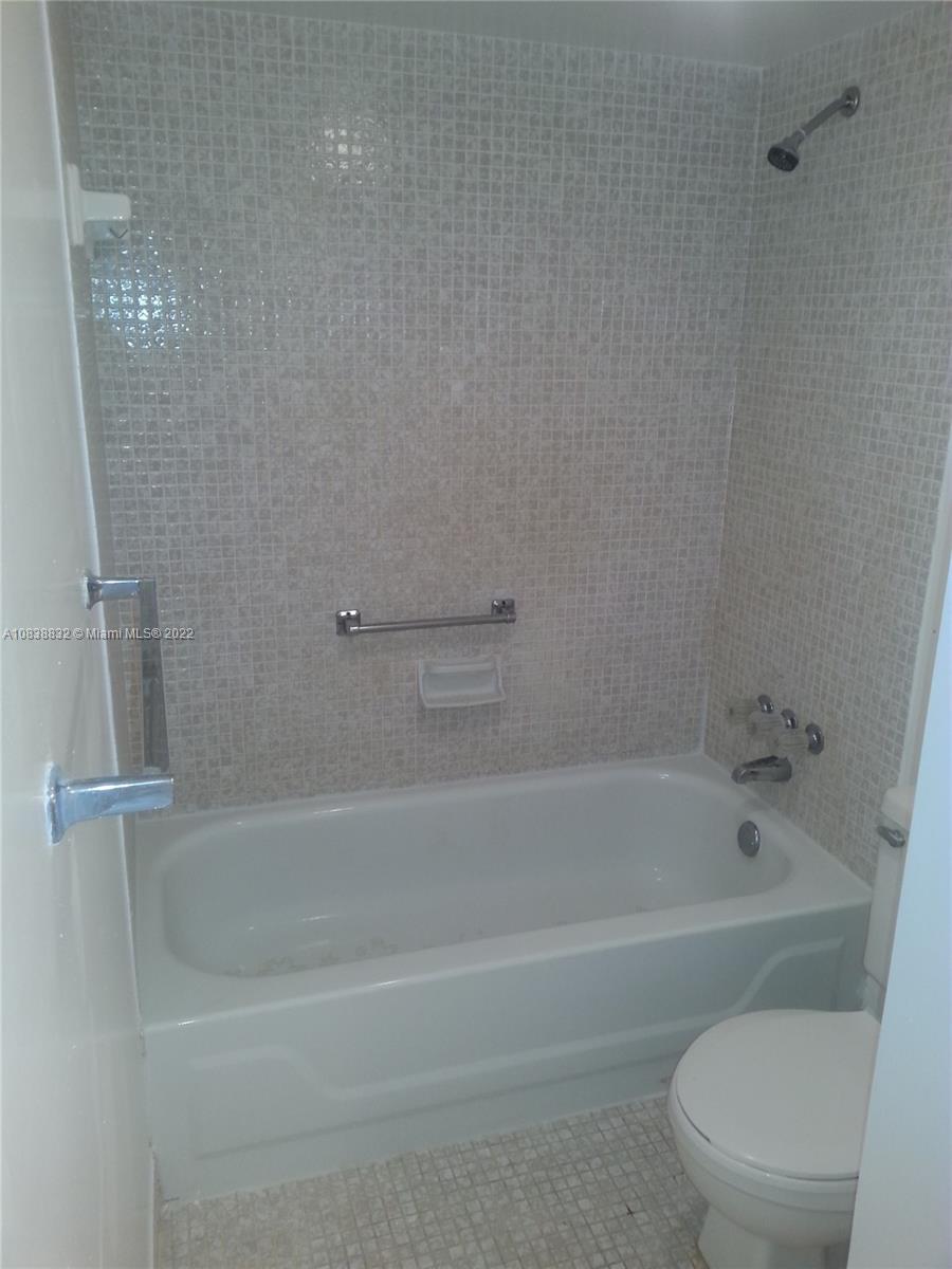 8411 Lagos De Campo Boulevard, Unit 303U Tamarac, FL 33321 - Photo 5 of 7 a bathroom with a bathtub and a toilet