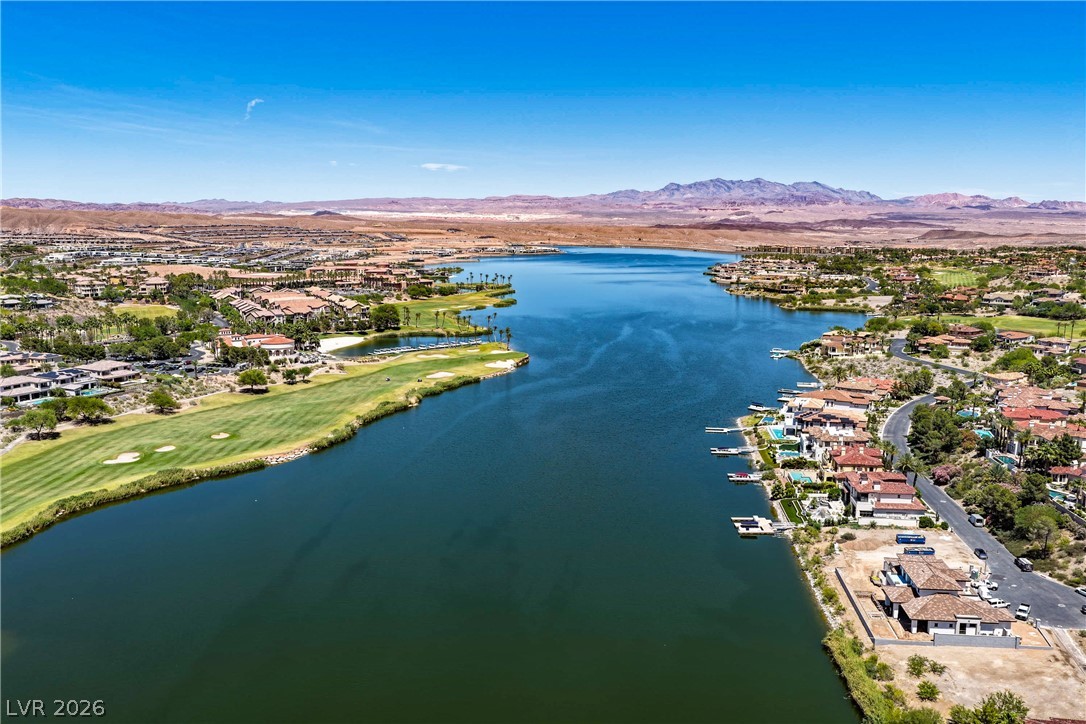 6 Rue Du Ville Henderson, NV 89011 - Photo 97 of 99 An aerial perspective reveals an expansive lakefront community nestled against rugged mountains.