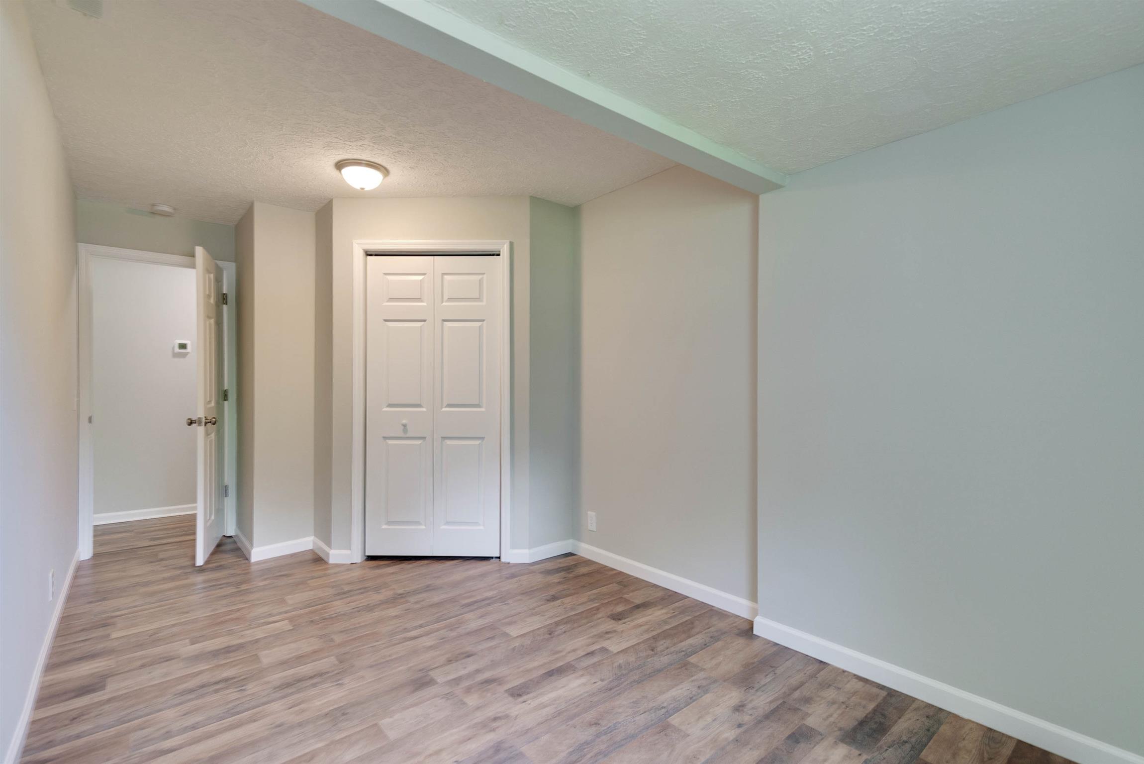 456 Boiling Springs Road Portland, TN 37148 - Photo 18 of 28 a view of an empty room with wooden floor