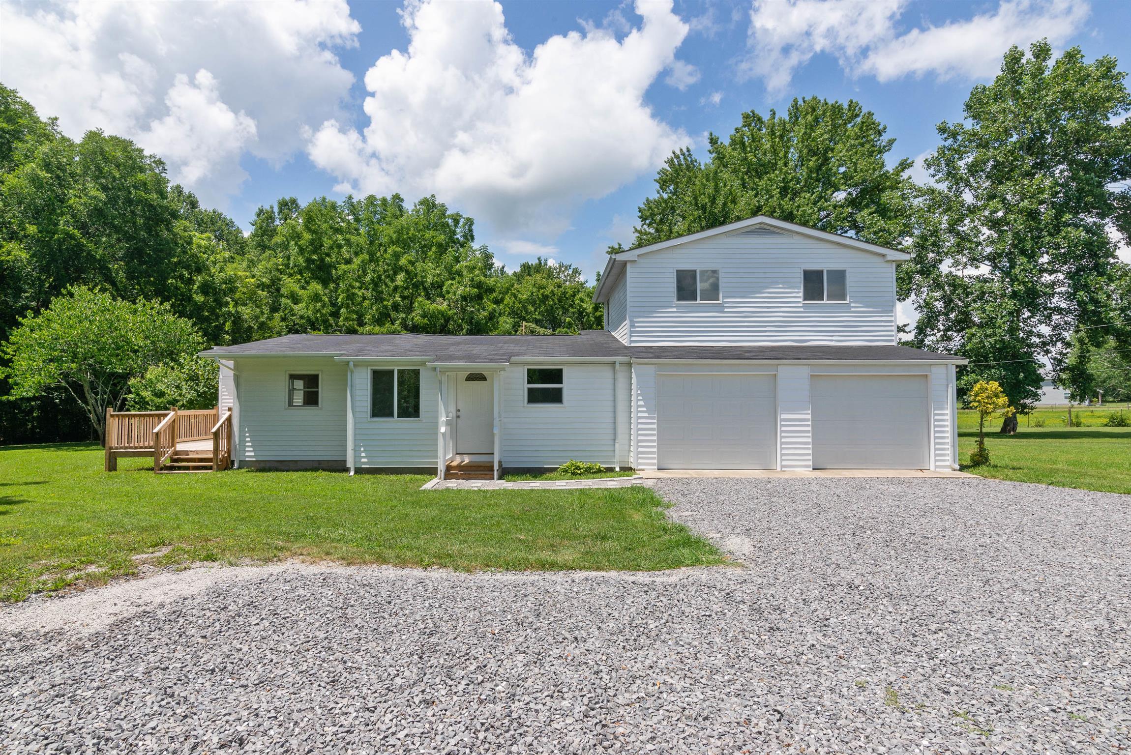 456 Boiling Springs Road Portland, TN 37148 - Photo 25 of 28 a front view of a house with a yard and garage