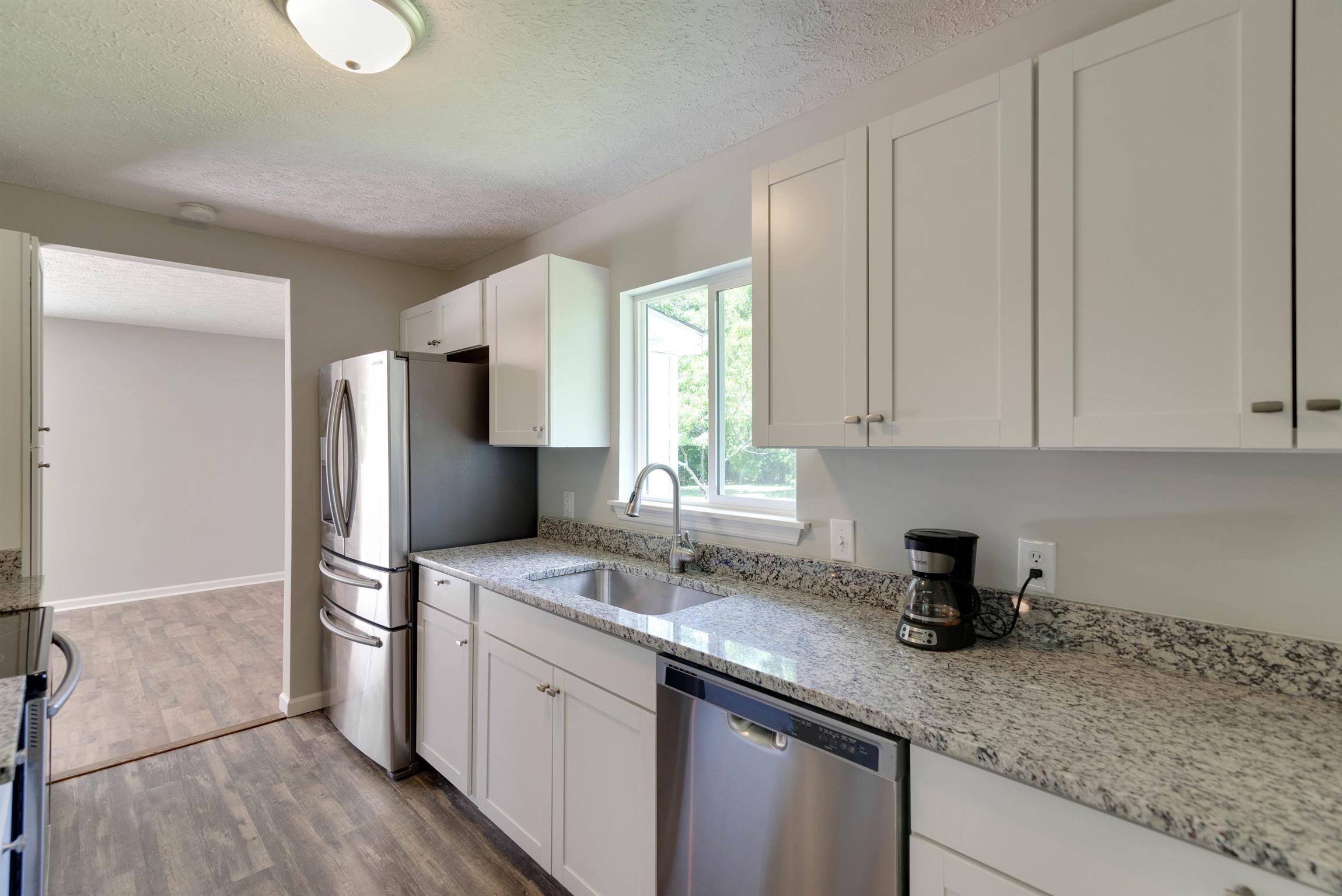 456 Boiling Springs Road Portland, TN 37148 - Photo 4 of 28 a kitchen with stainless steel appliances granite countertop a sink a refrigerator and a granite counter tops