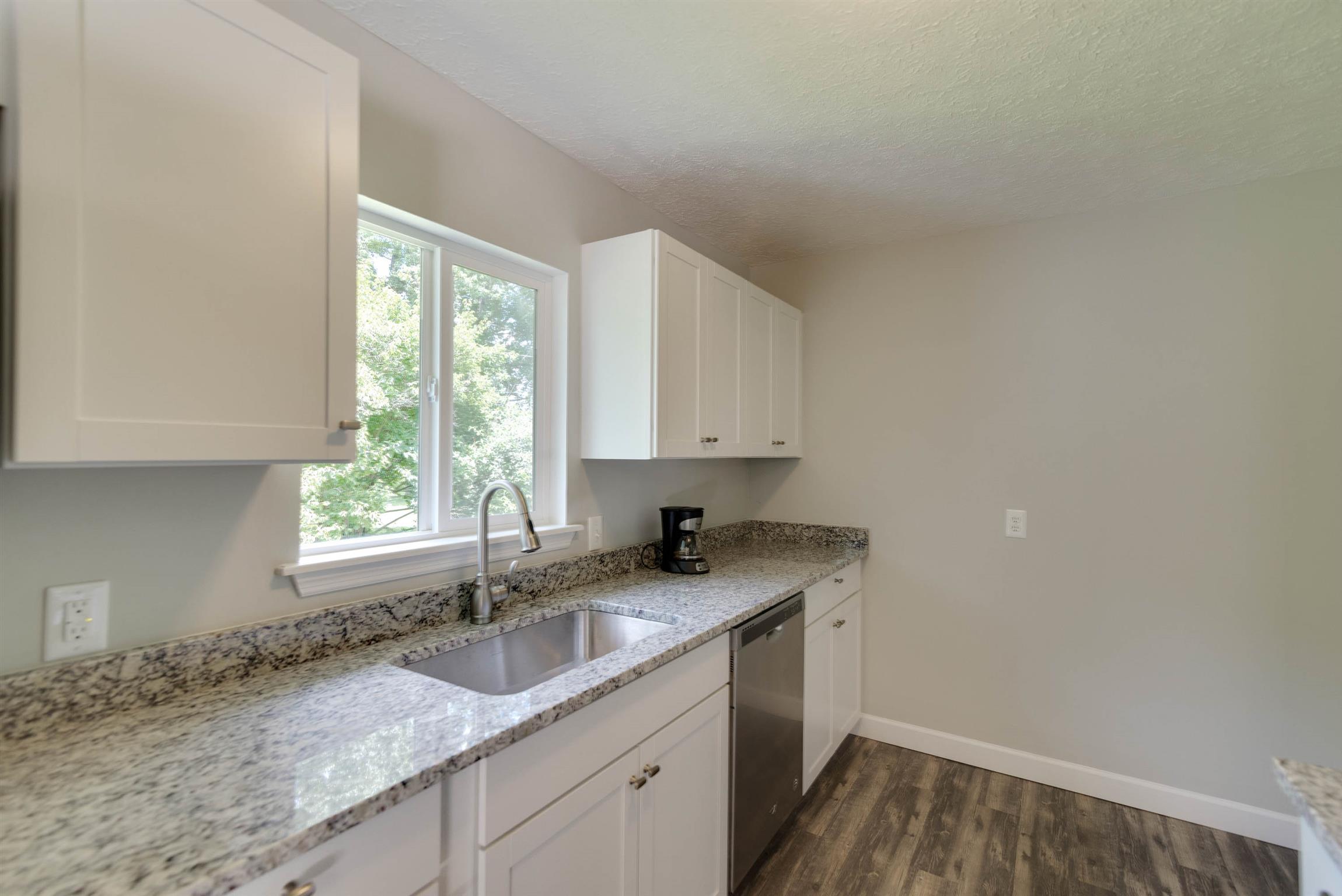 456 Boiling Springs Road Portland, TN 37148 - Photo 5 of 28 a kitchen with granite countertop cabinets sink and window